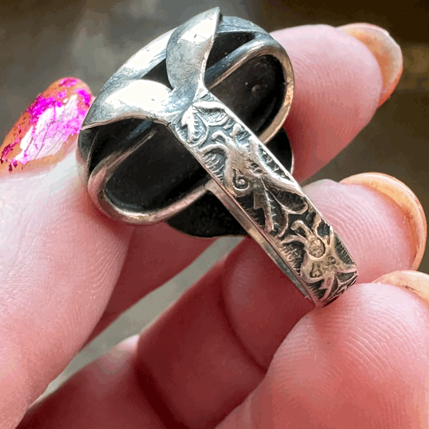 Goldstone set in fanciful floral stamped silver band sz. 7.5
