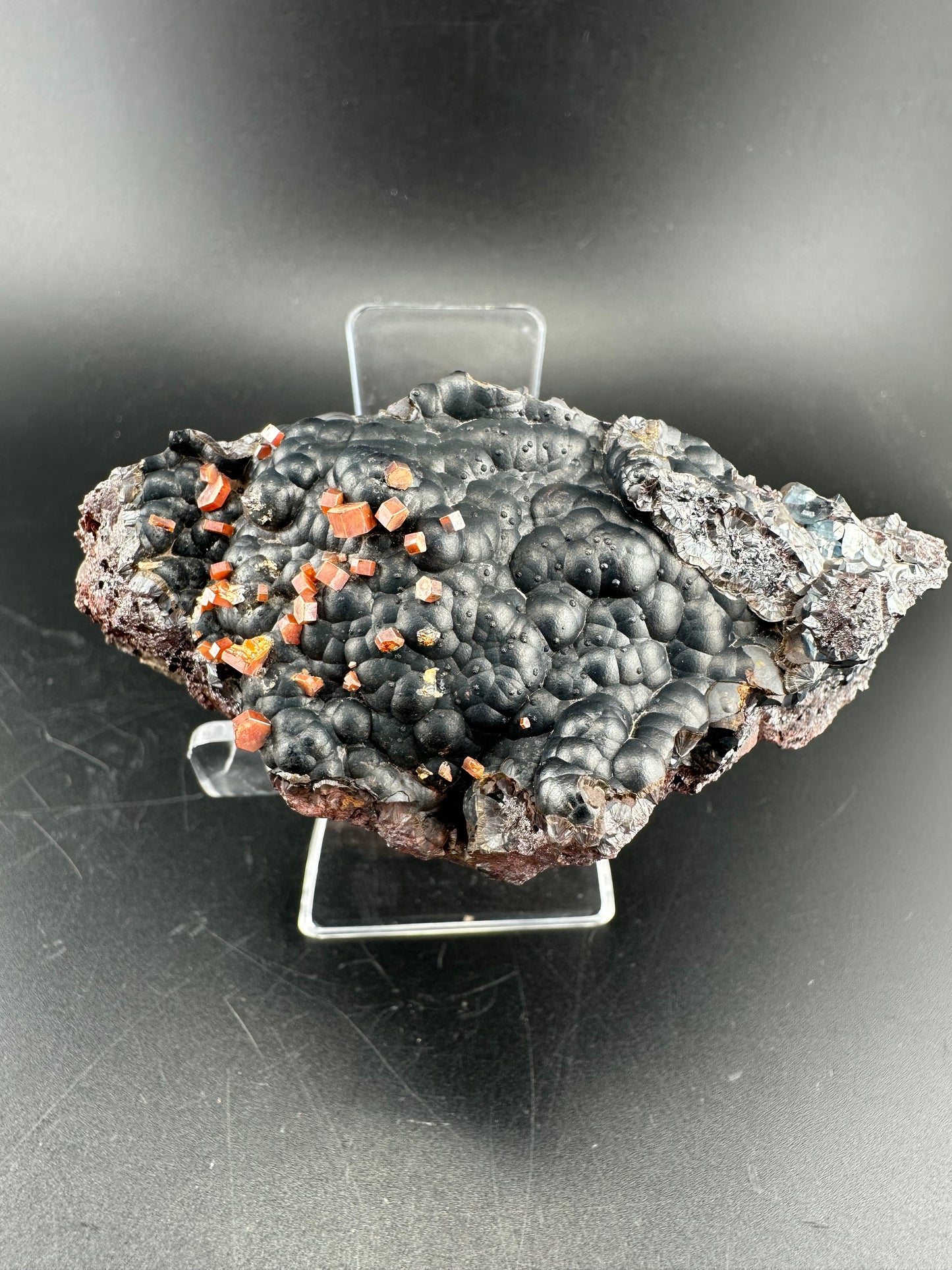 Vanadinite on botryoidal hematite: Morocco