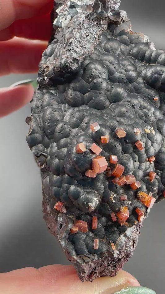 Vanadinite on botryoidal hematite: Morocco